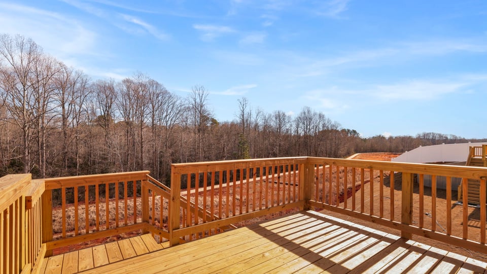 Back exterior with deck and large backyard.