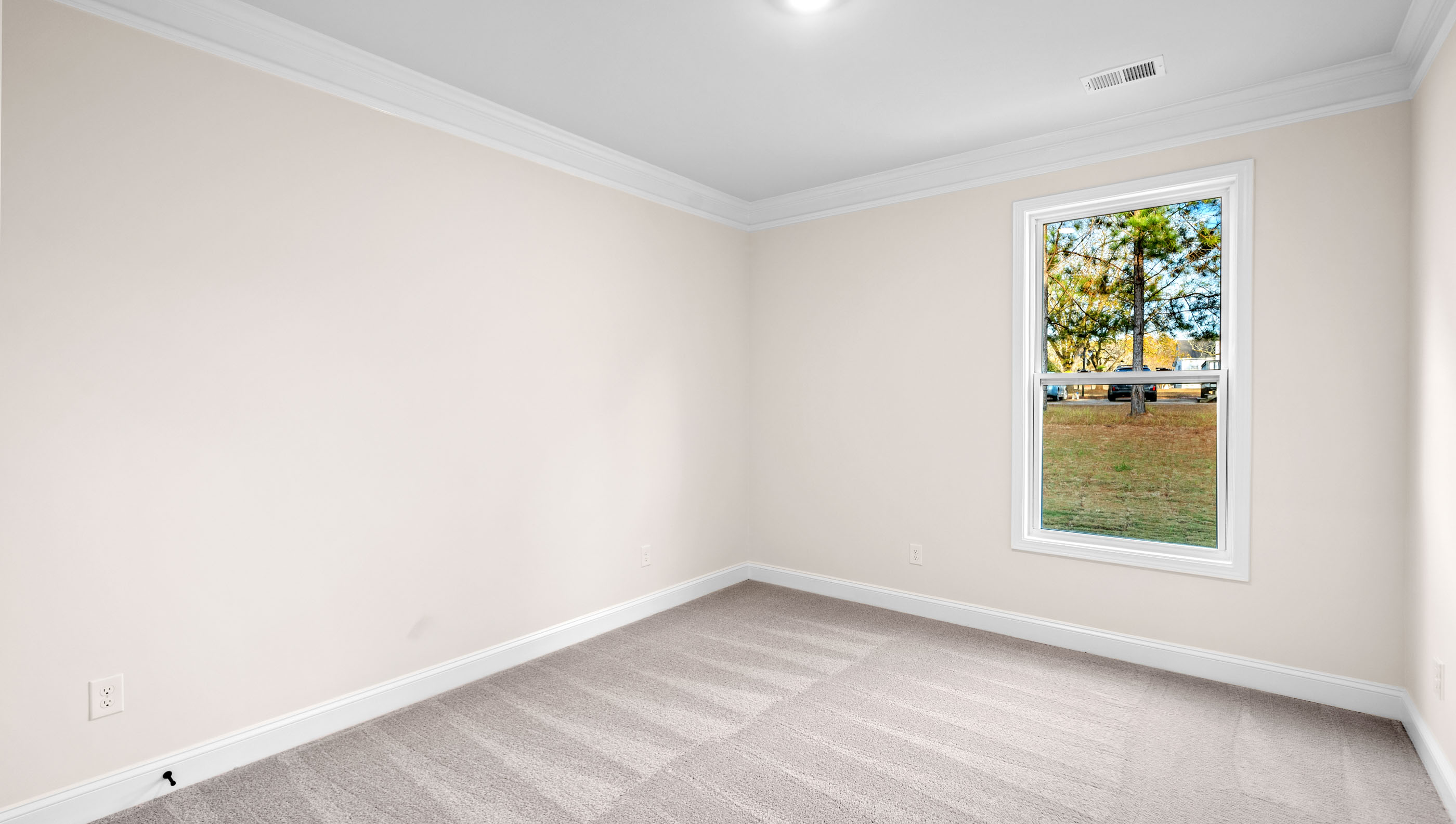 Bedroom with carpet and window.