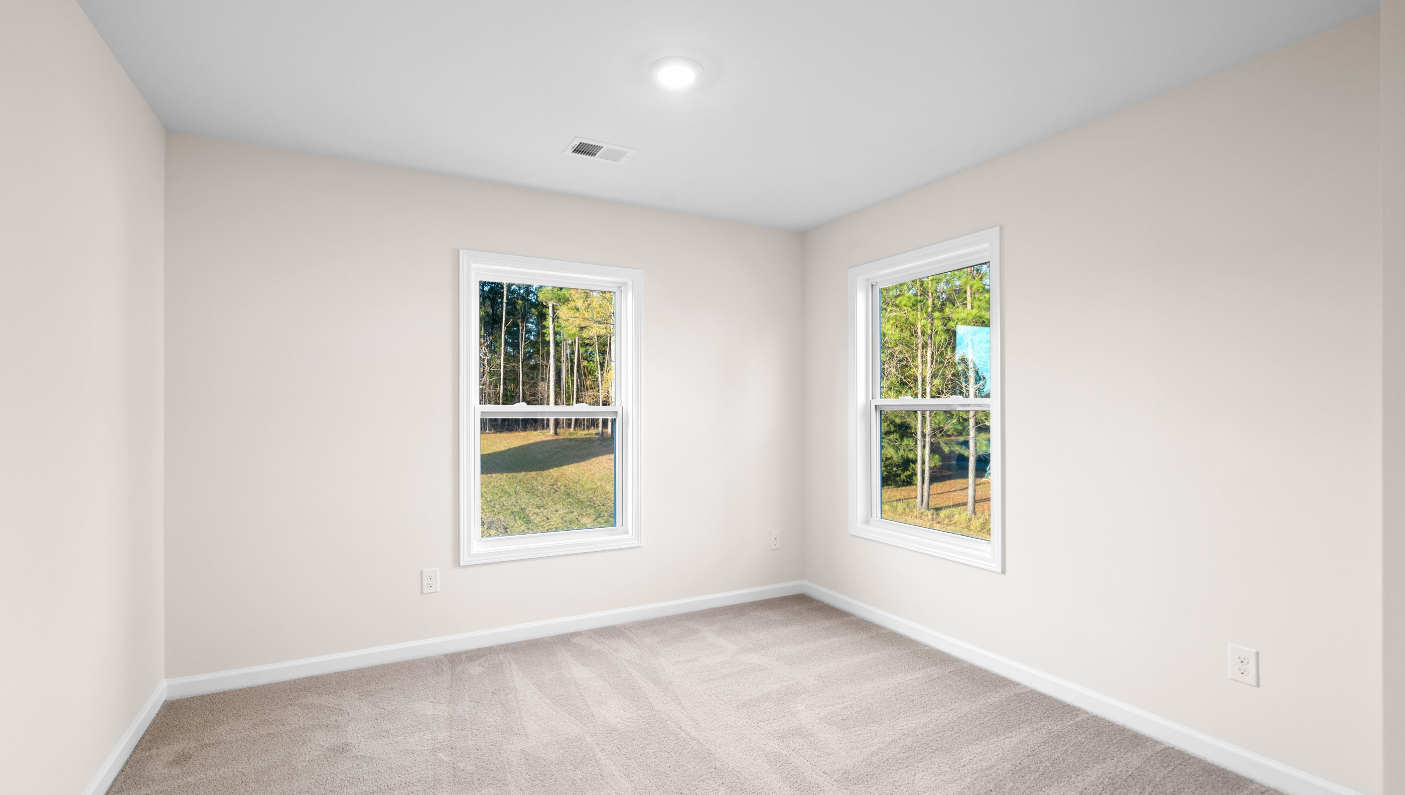 Bedroom with carpet and window.