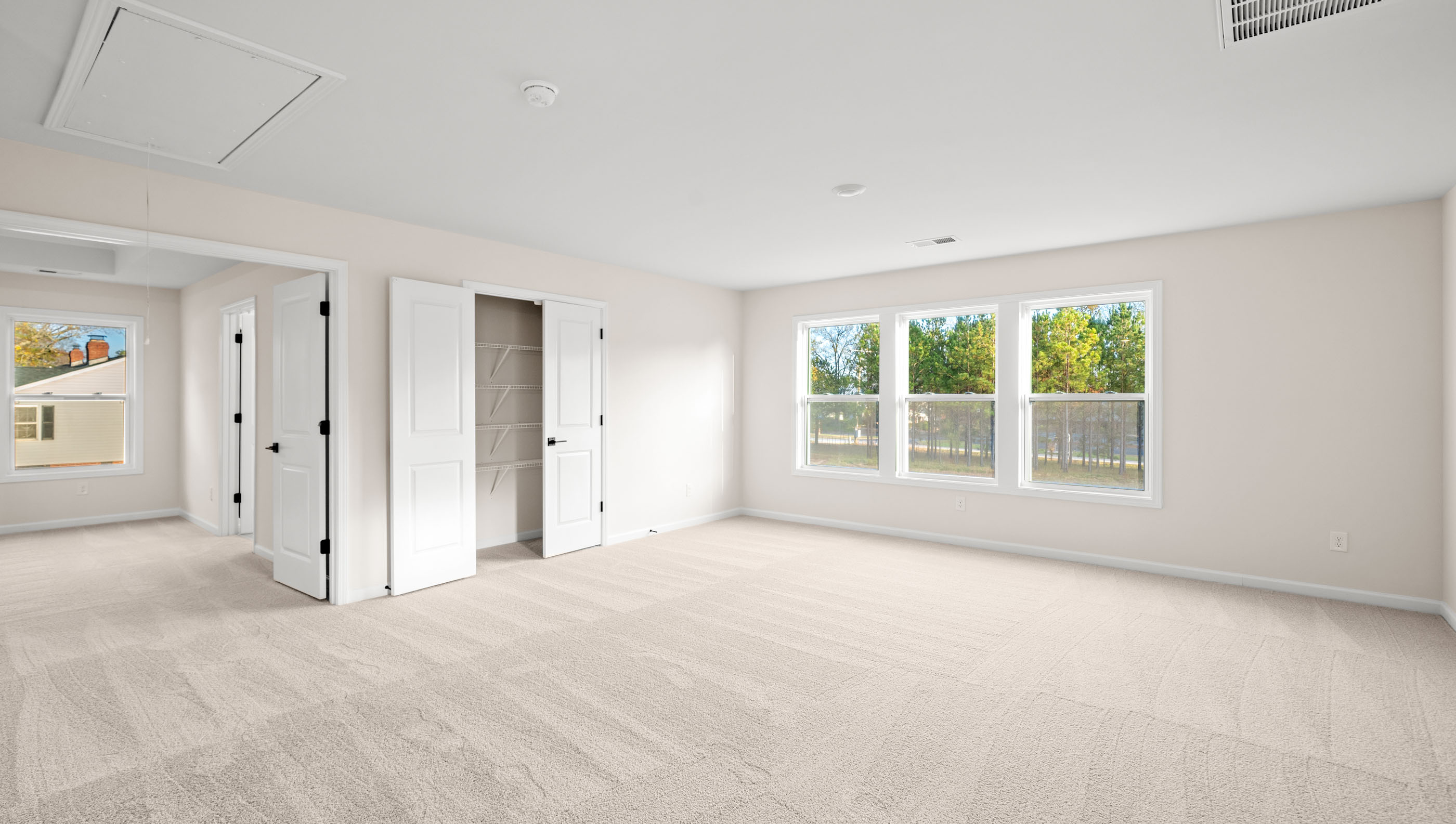 Bedroom with carpet and windows.