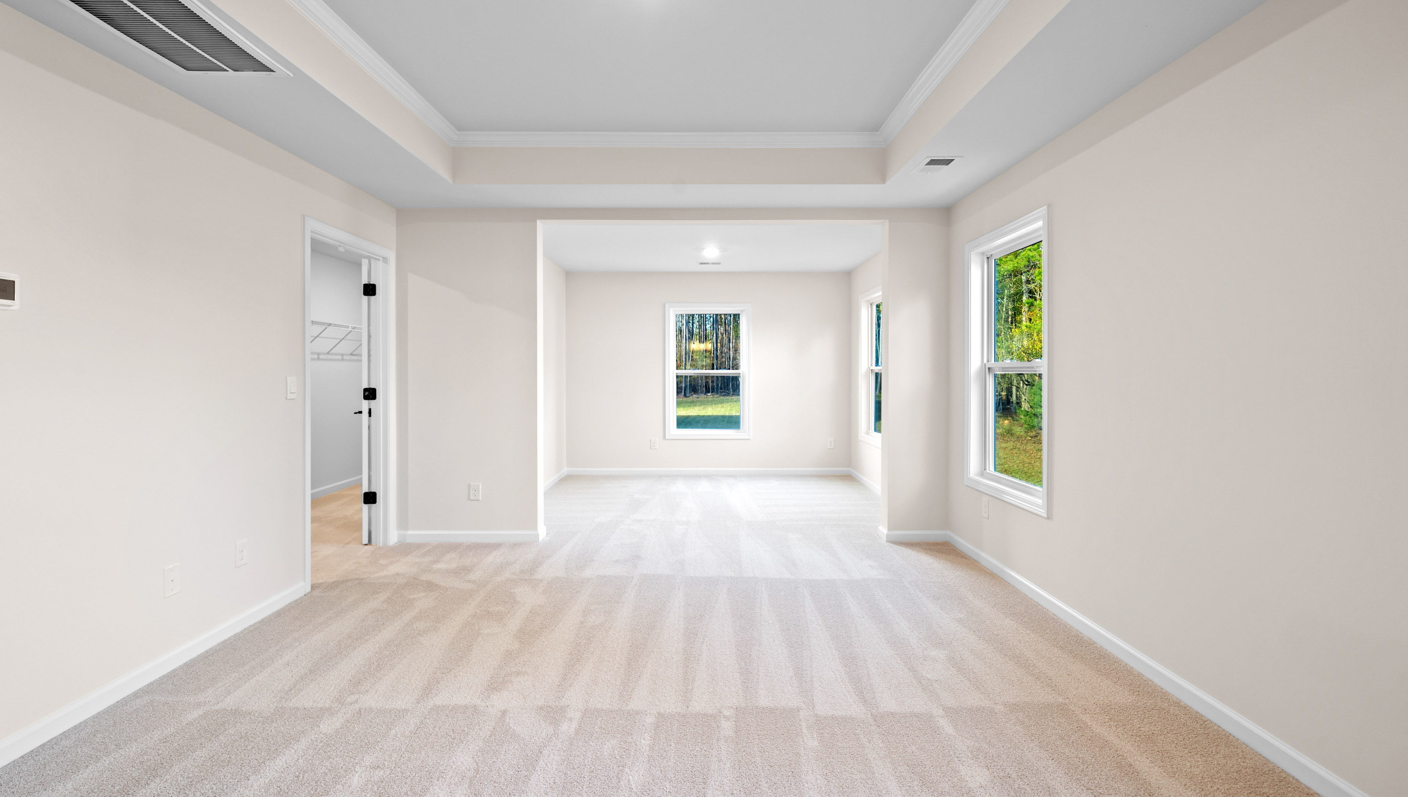 Bedroom with carpet and windows.