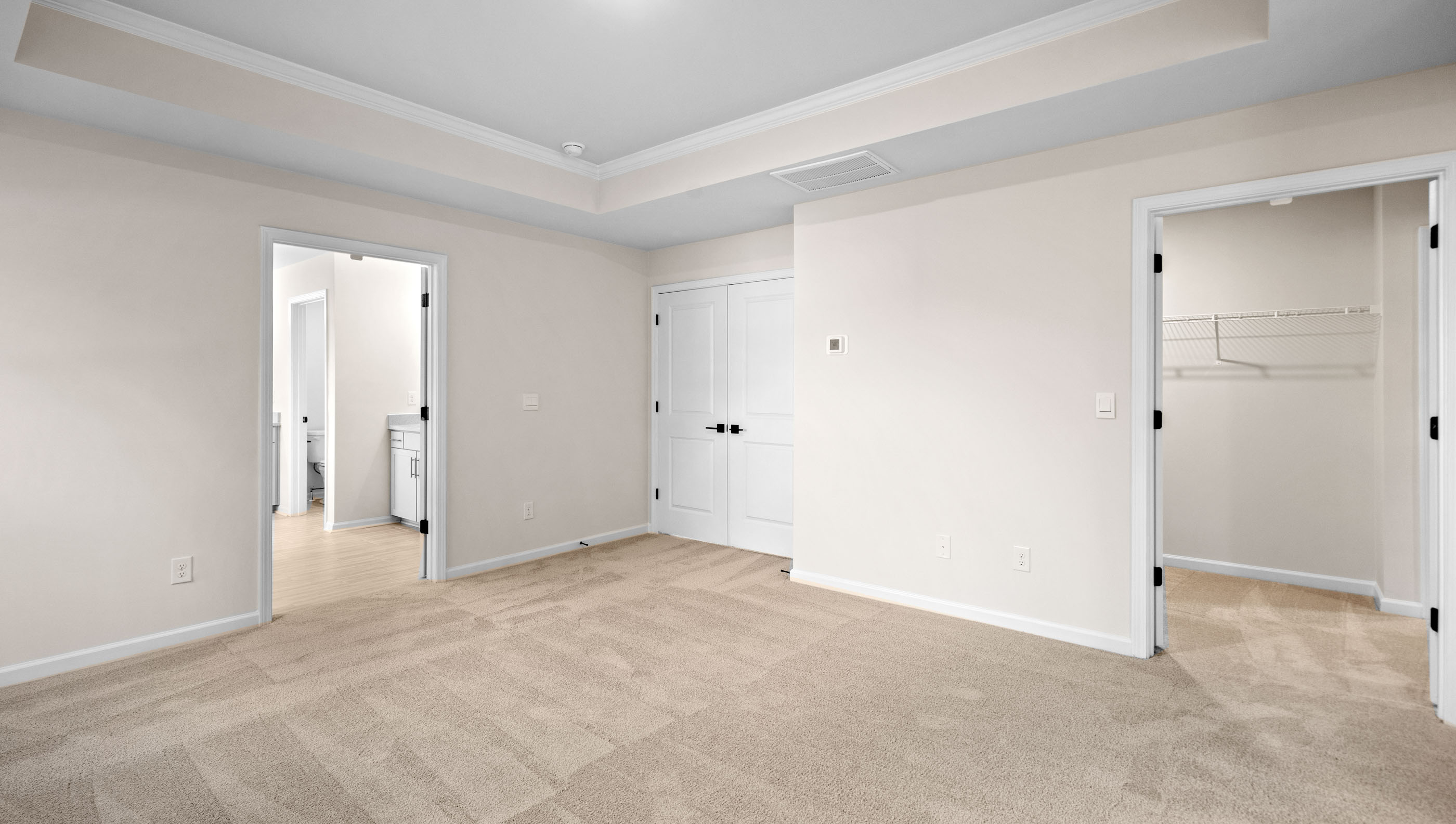 Bedroom with carpet and windows.