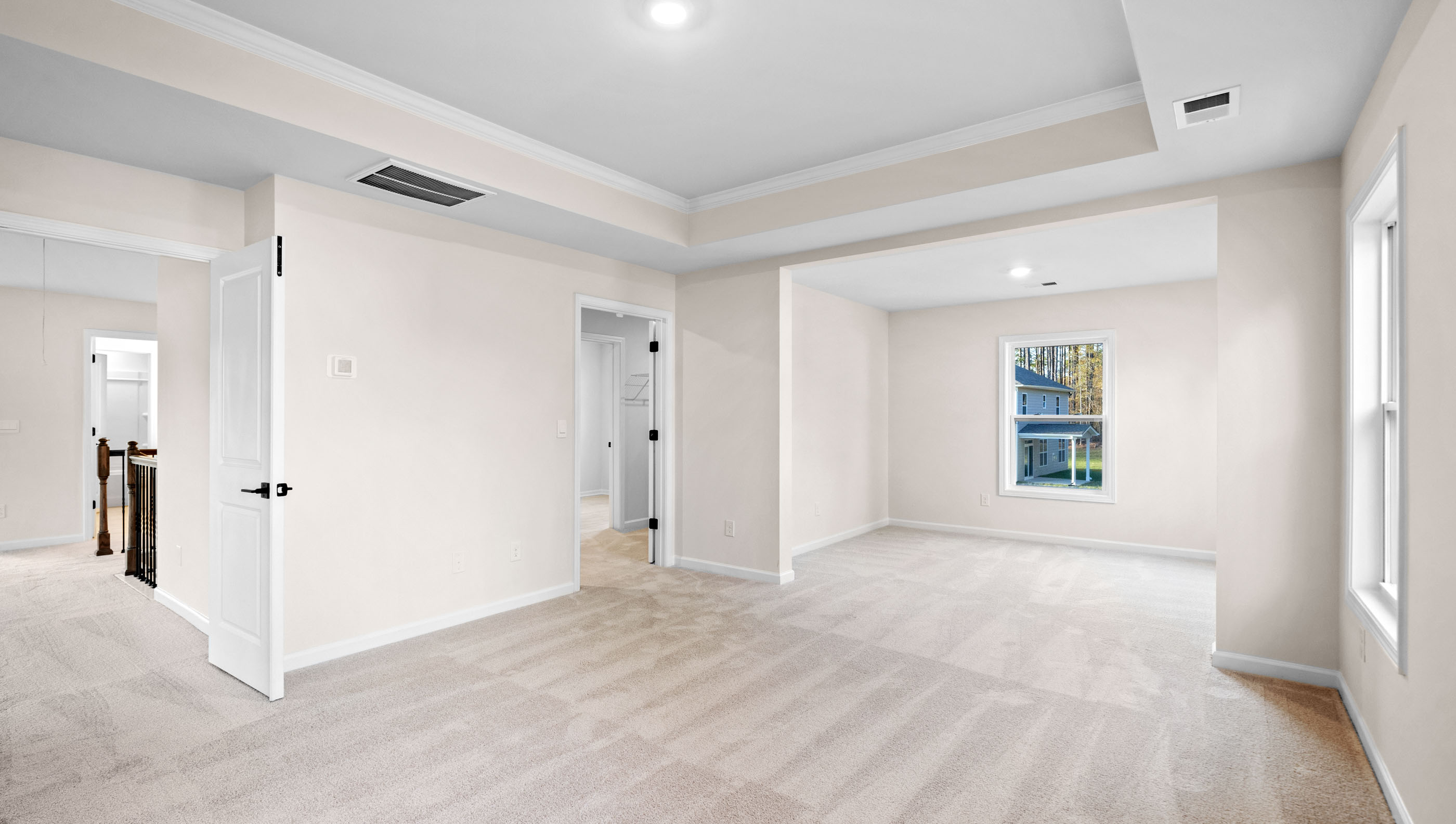 Bedroom with carpet and windows.