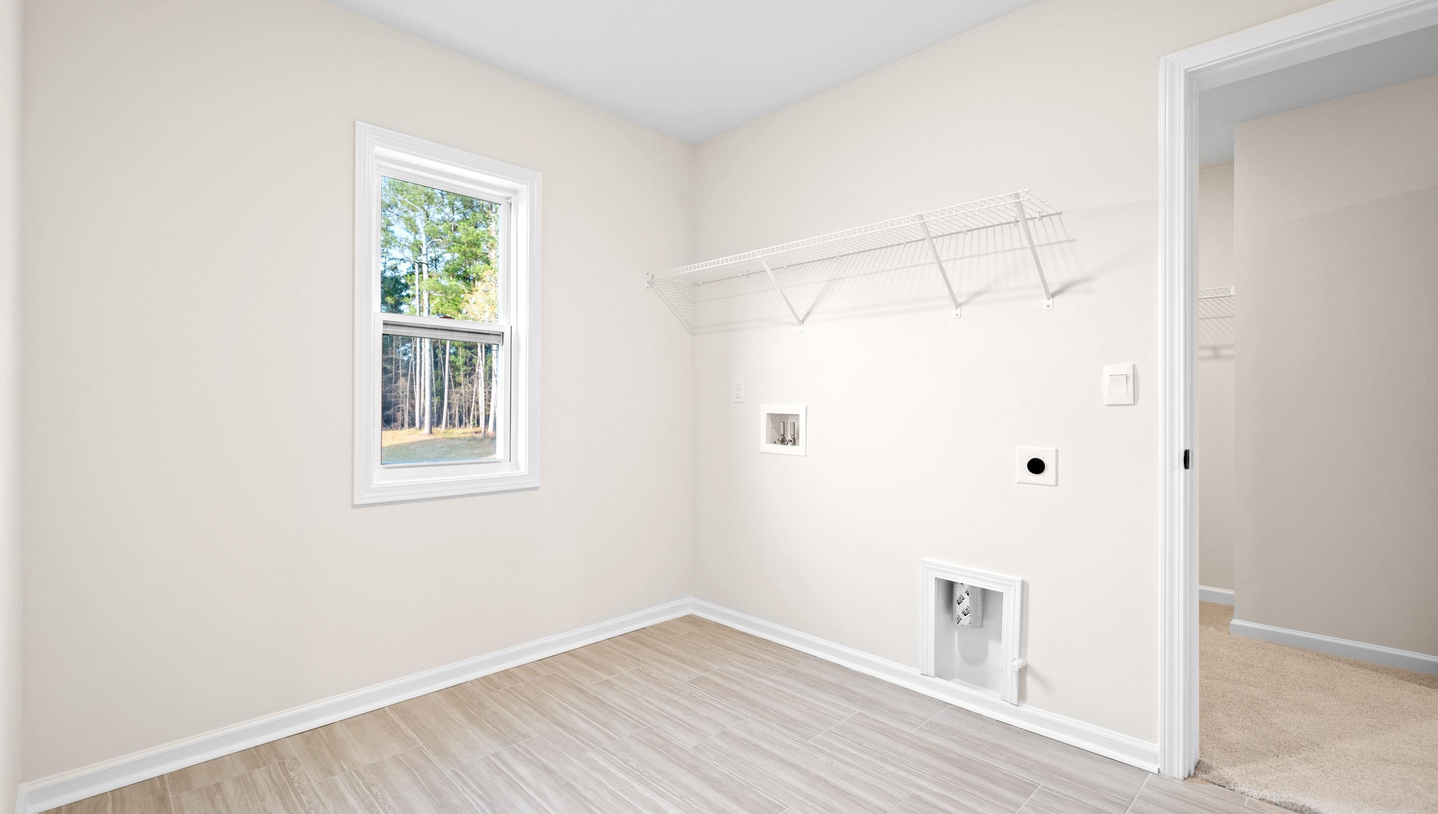 Laundry room with storage racks.