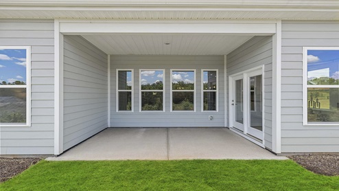 Back exterior of home with covered patio area.