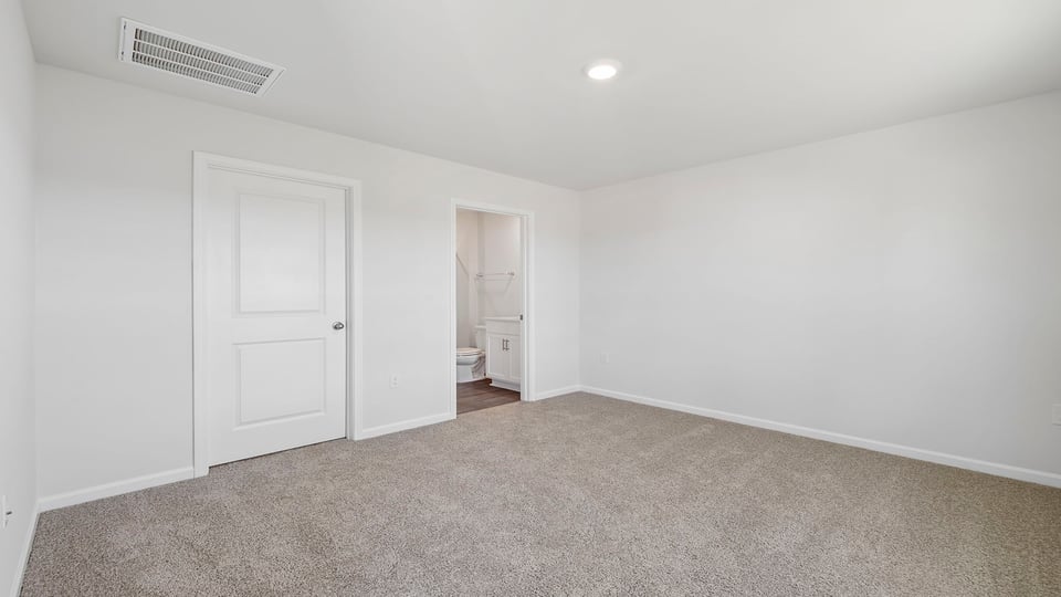 Bedroom with carpet and window.