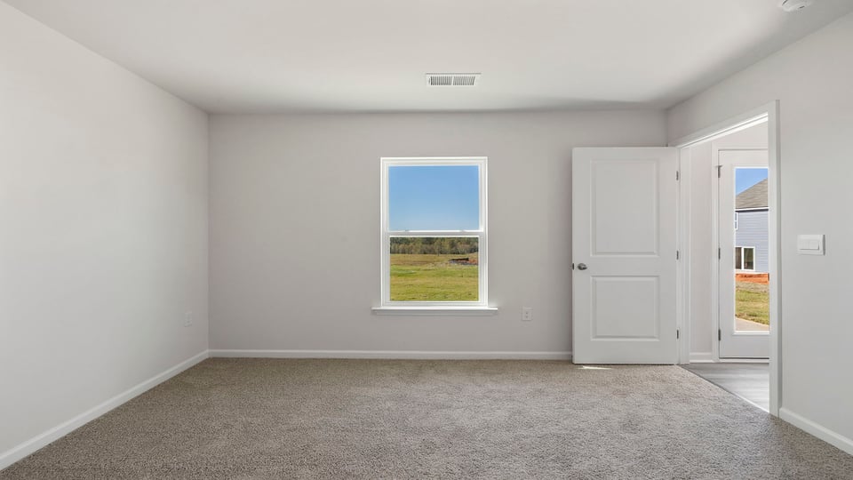Bedroom with carpet and window.