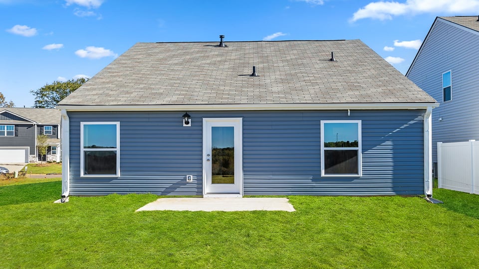 Exterior of home with large backyard.