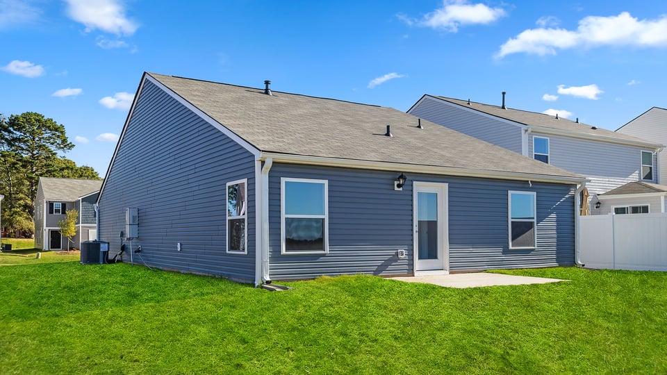 Exterior of home with large backyard.