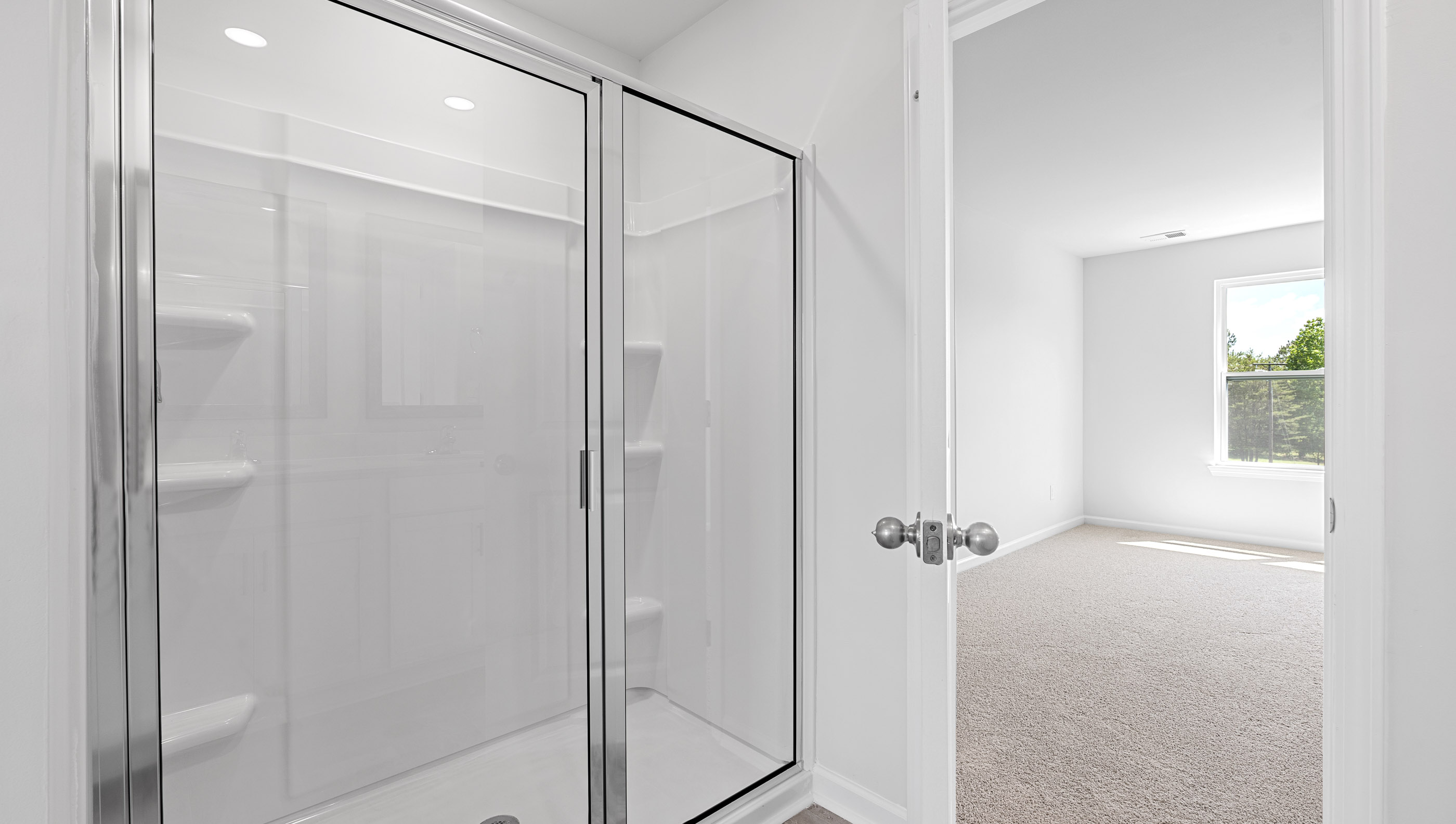 Bathroom with vanity and walk in shower.