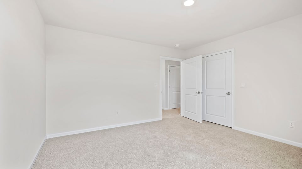 Bedroom with carpet and window.