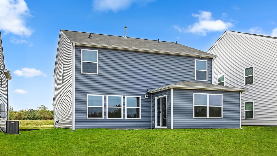 Exterior of home with large backyard.