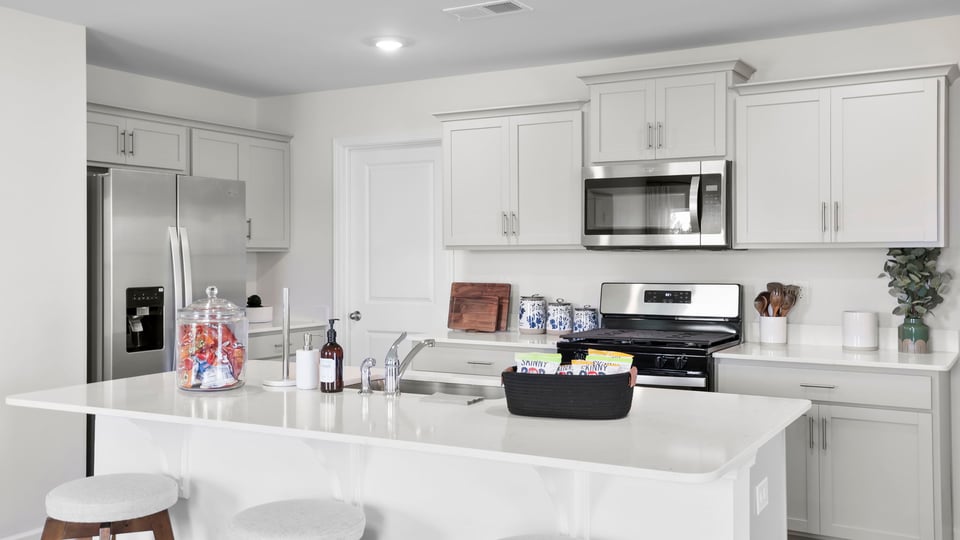 Kitchen and island with quartz countertops.