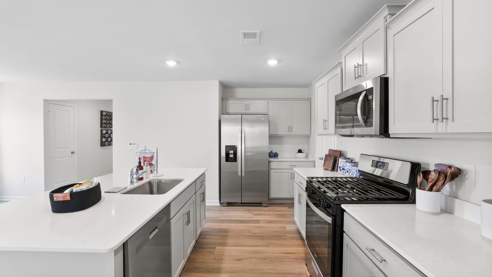 Kitchen and island with quartz countertops.