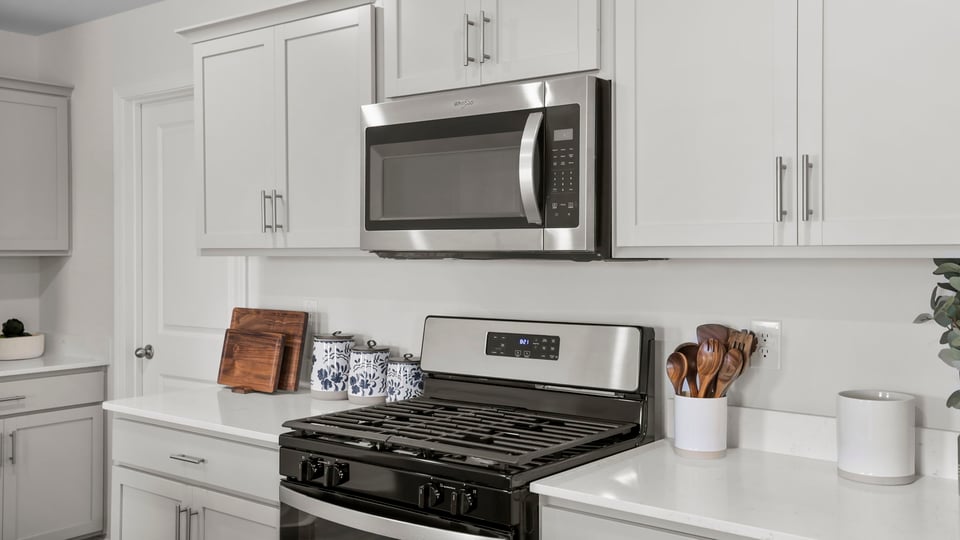 Kitchen and island with quartz countertops.