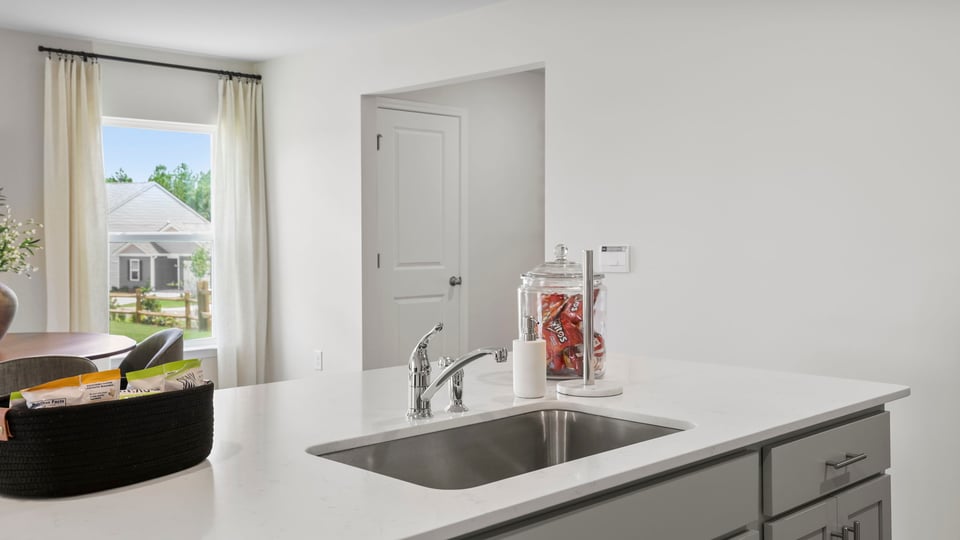 Kitchen and island with quartz countertops.