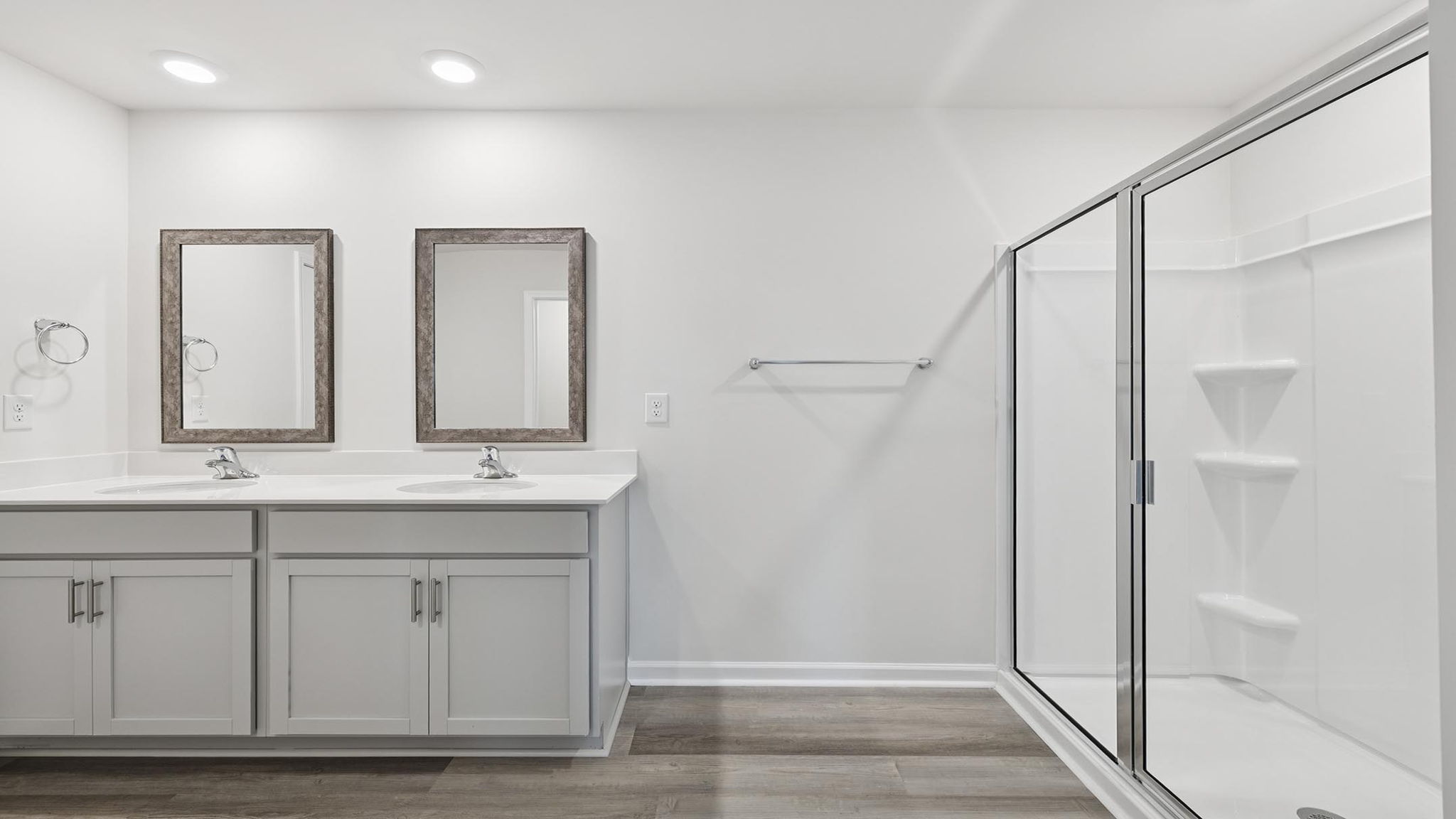 Bathroom with vanity and walk in shower.