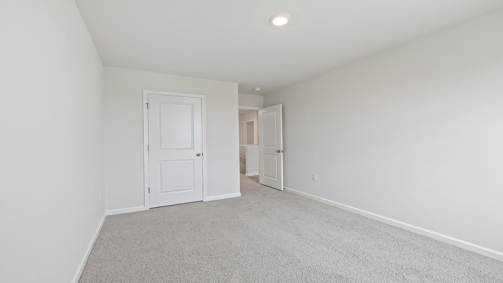 Bedroom with carpet and window.