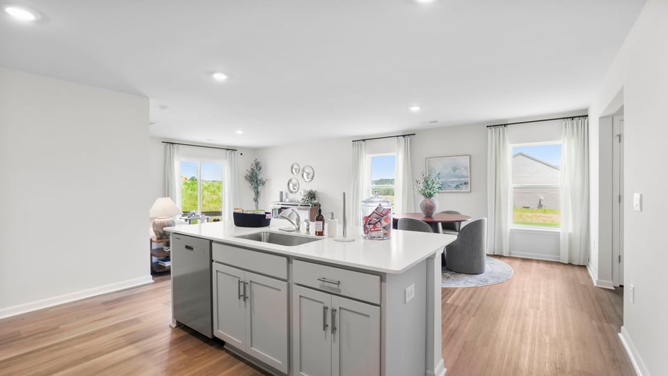 Kitchen and island with quartz countertops.