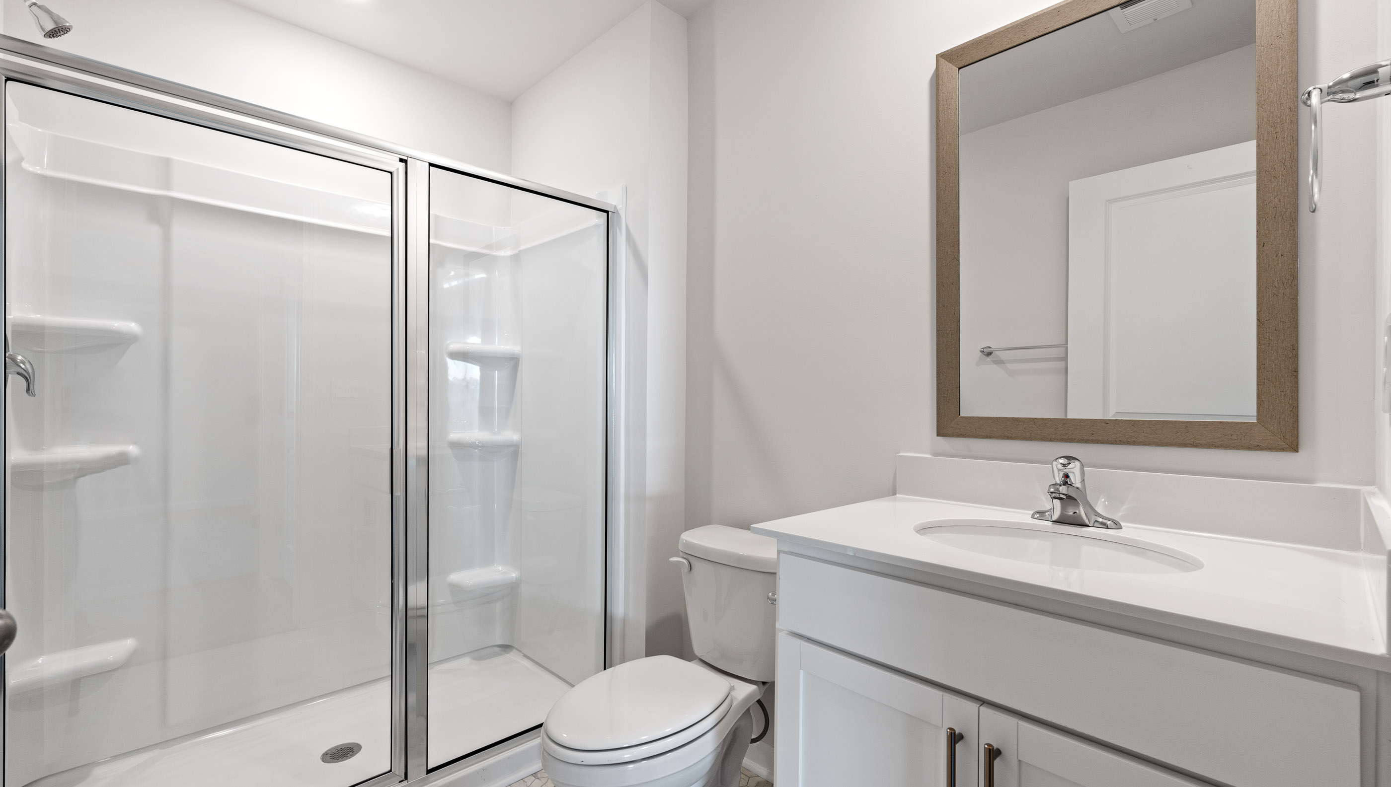 Bathroom with vanity and shower.