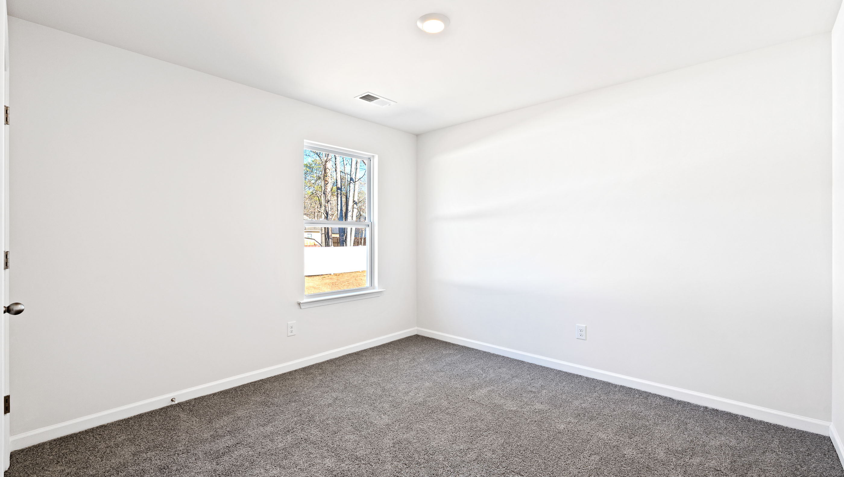 Bedroom with carpet and windows.