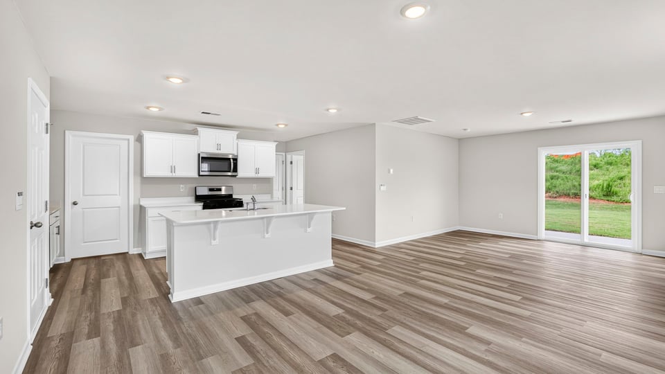 View of full kitchen and sliding glass back door
