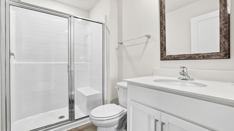 Upstairs bathroom with glass shower and toilet