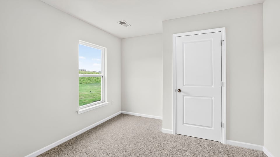 Bedroom with carpet and window