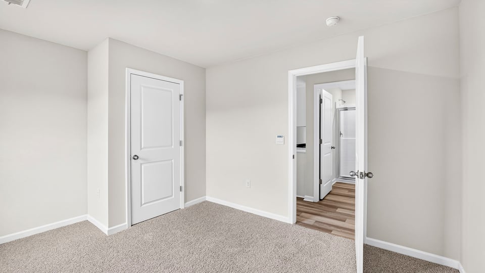 Bedroom with carpet and closet