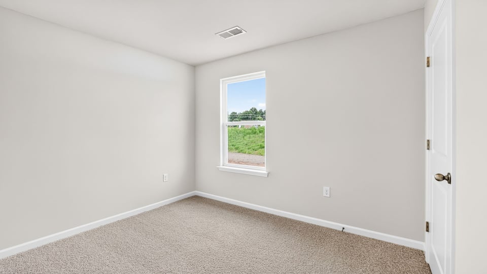 Bedroom with carpet and window