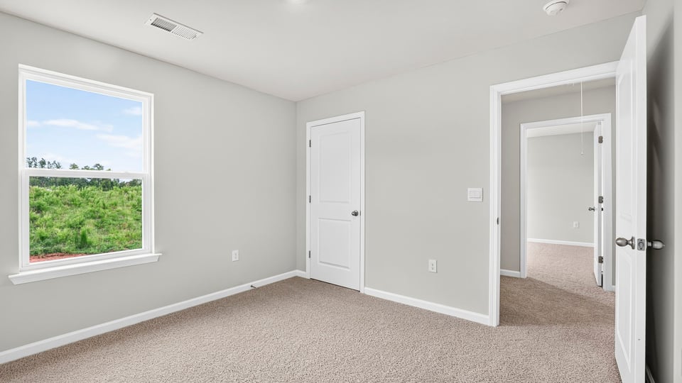 Bedroom with carpet and closet