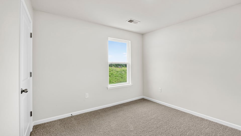 Bedroom with carpet and window