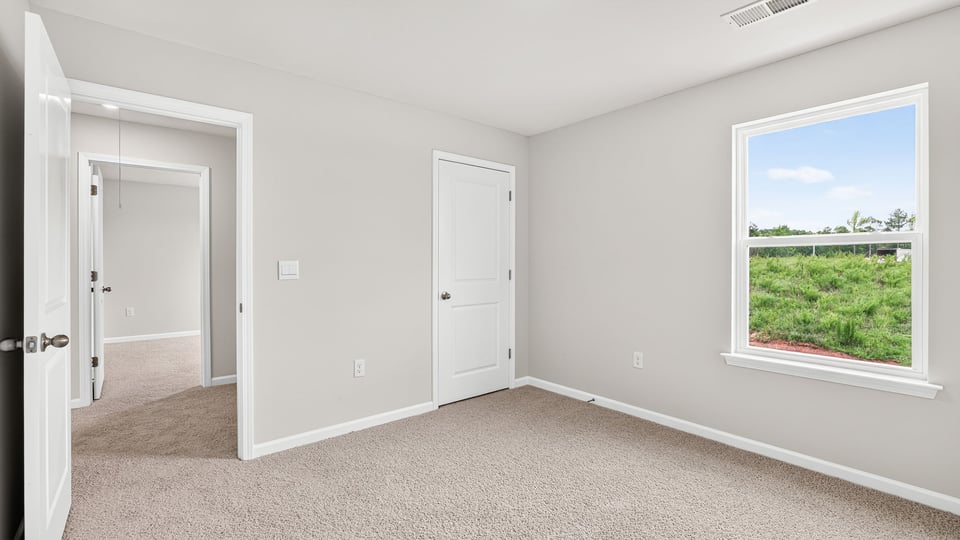 Bedroom with carpet and closet