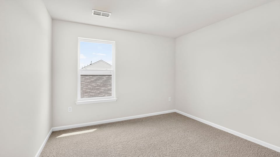 Bedroom with carpet and window