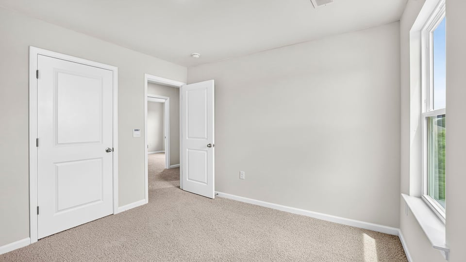 Bedroom with carpet and closet