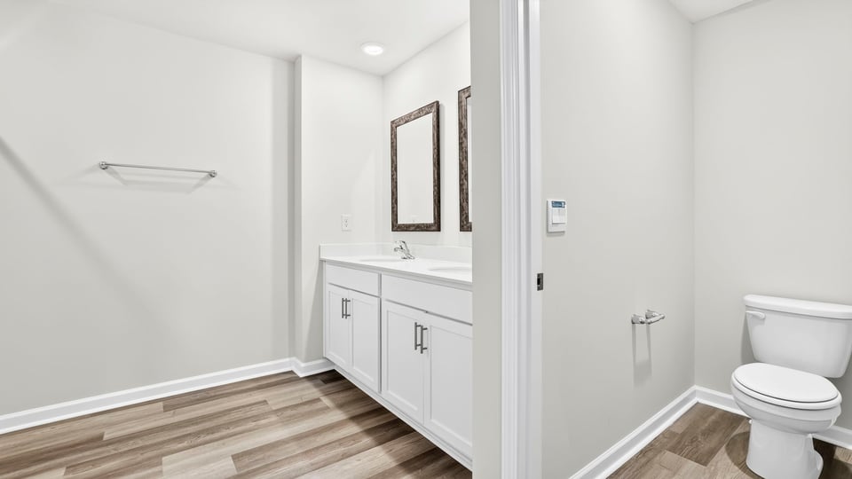 Primary bathroom with double vanity sink and toilet