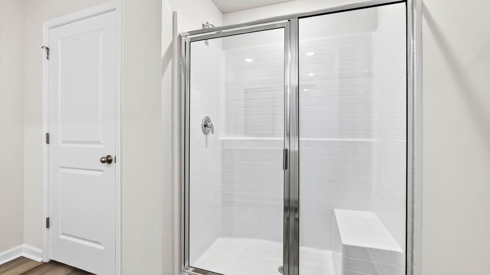 Primary bathroom with glass shower and closet
