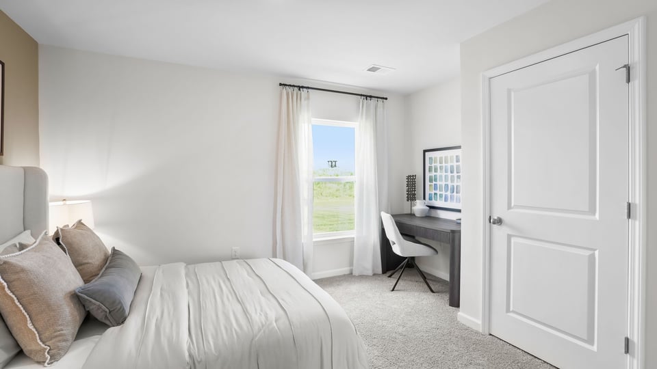 Bedroom with carpet and window.a
