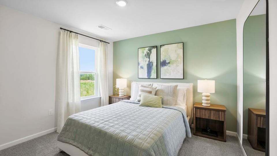 Bedroom with carpet and window.a
