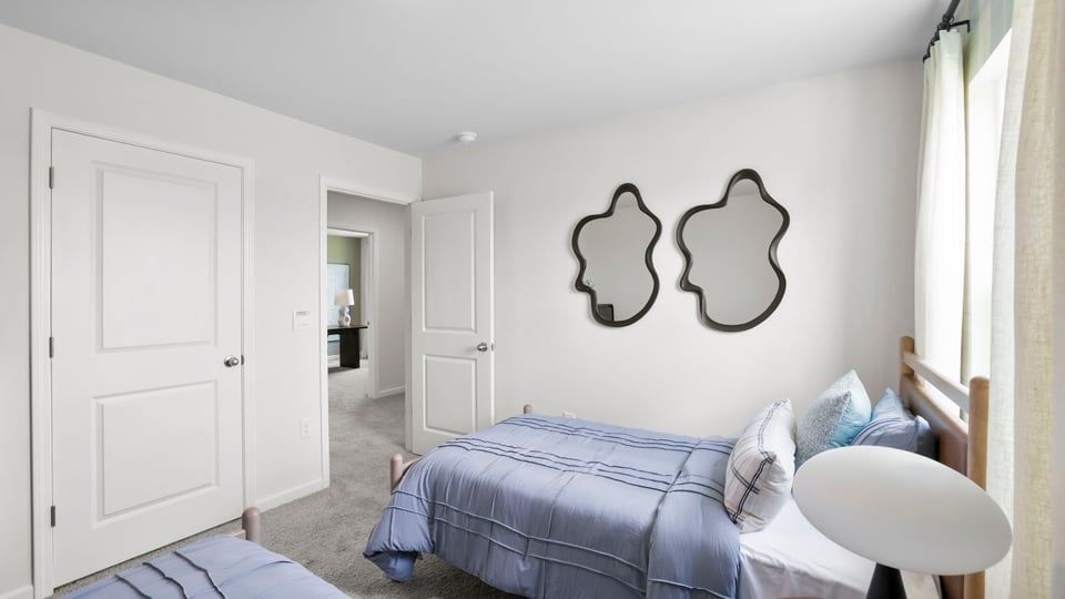 Bedroom with carpet and window.