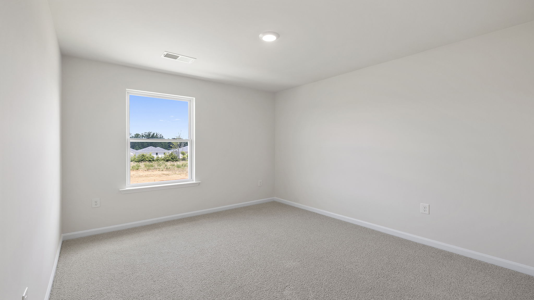 Bedroom with carpet and windows.
