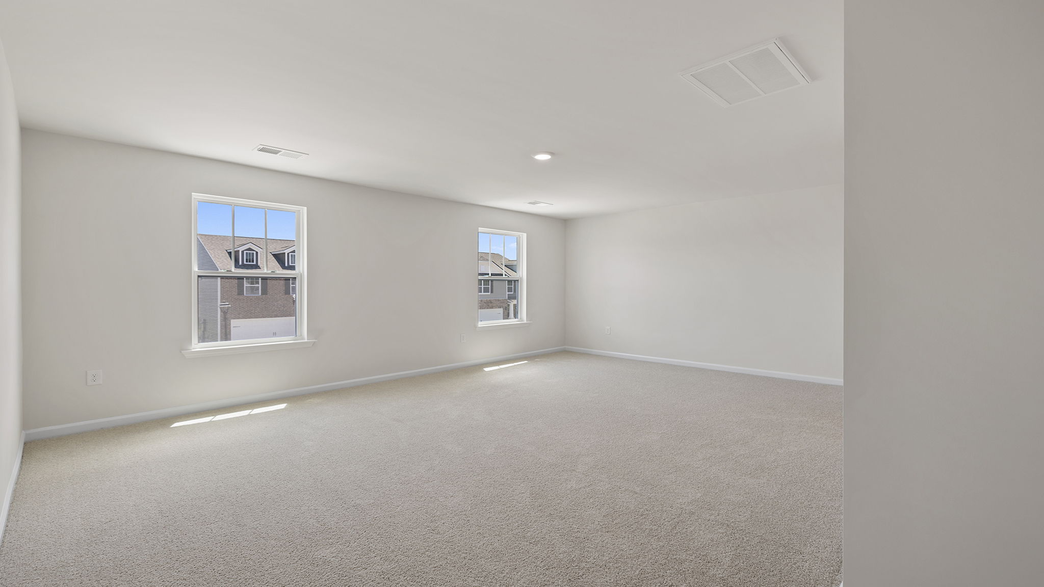 Bedroom with carpet and windows.