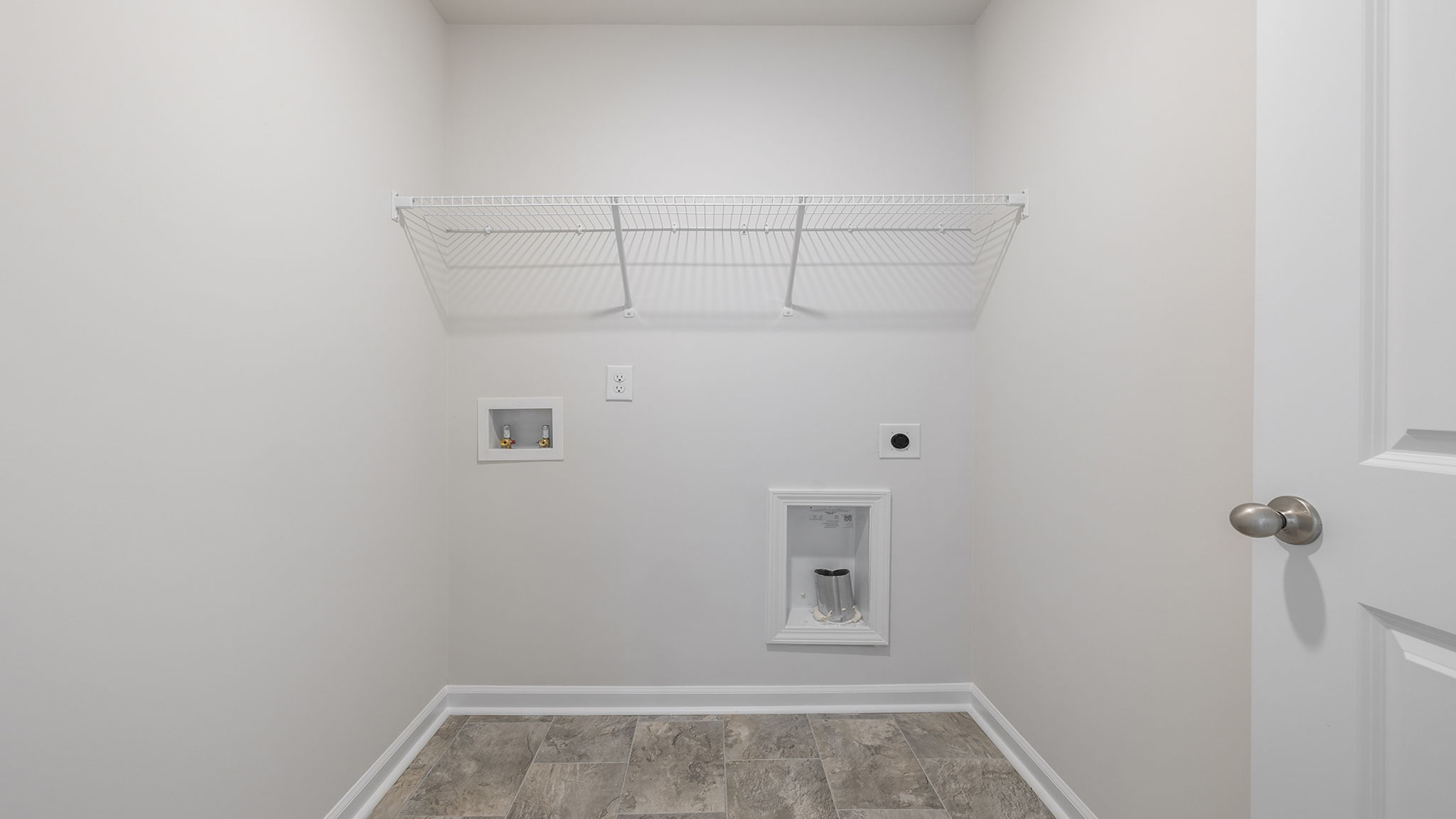 Walk in laundry with shelves.