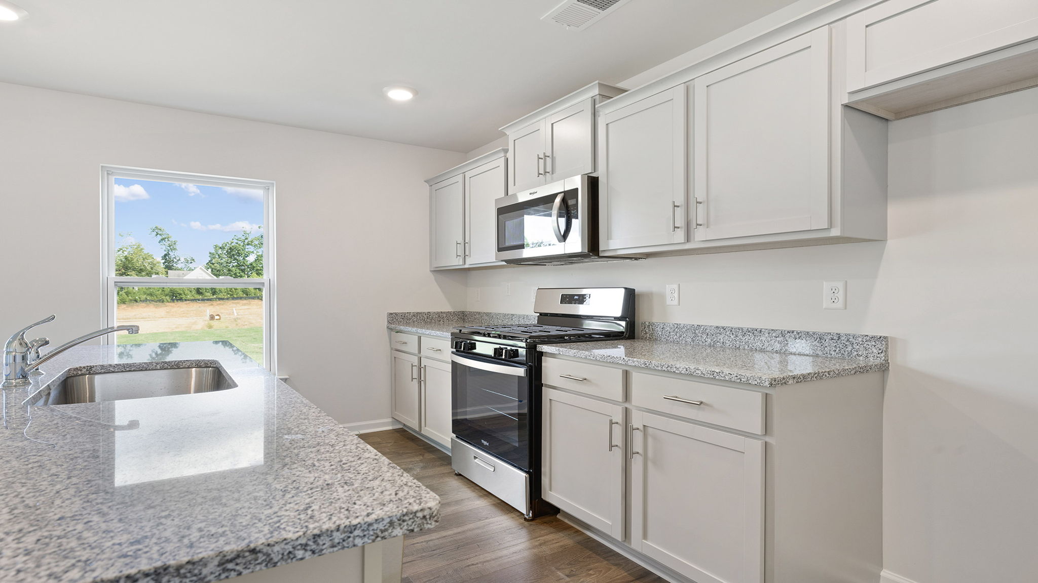 Kitchen and island with granite countertops.