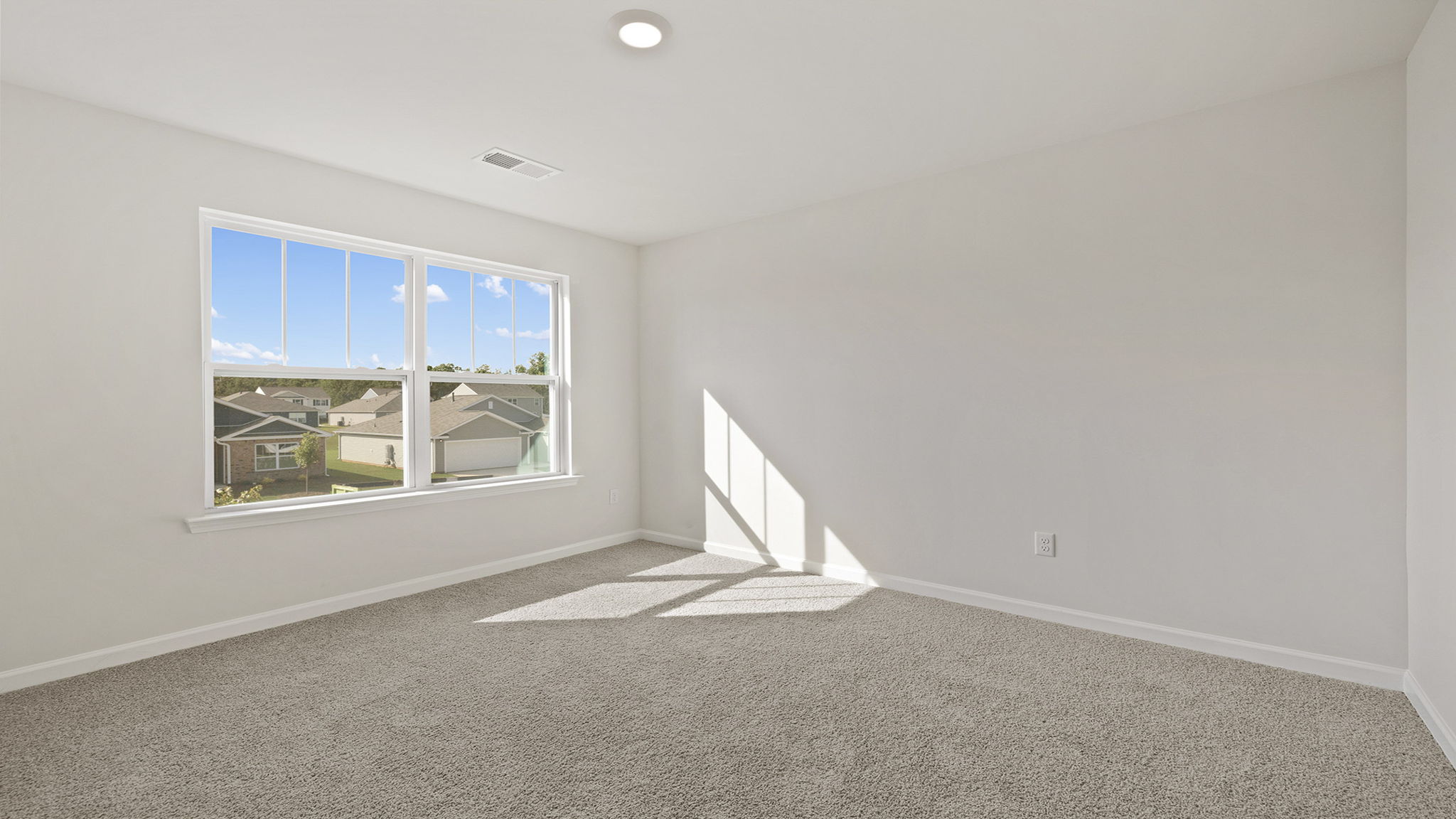 Bedroom with carpet and windows.
