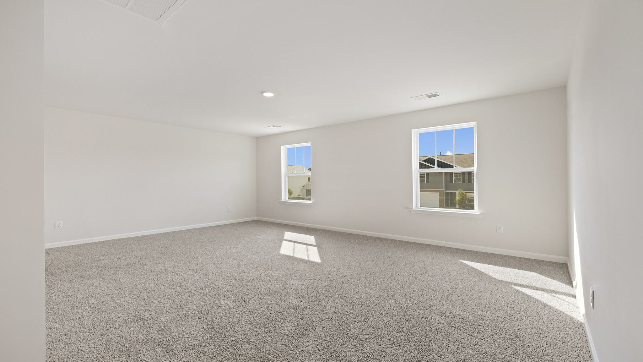 Bedroom with carpet and windows.