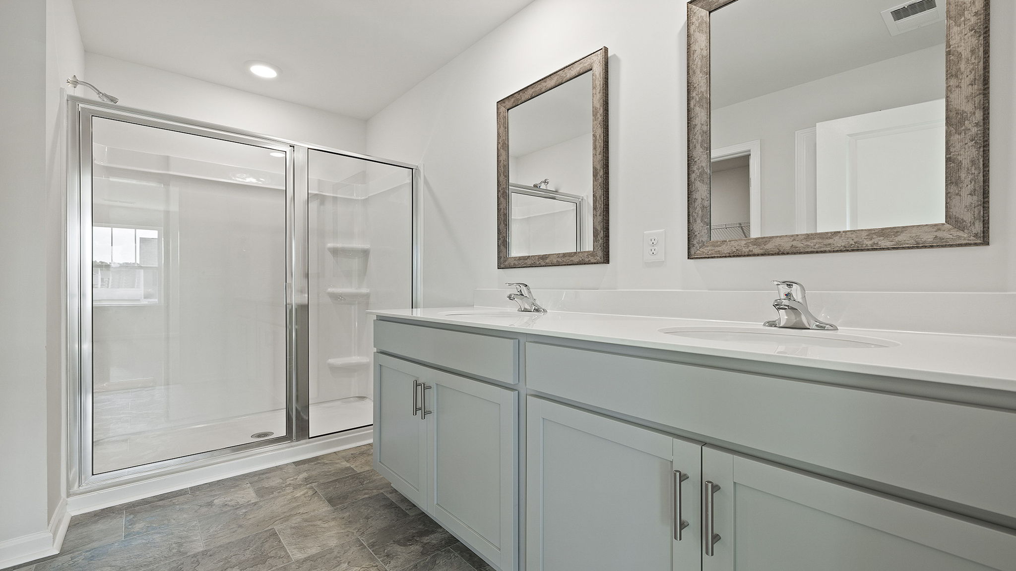 Bathroom with vanity and walk in shower.