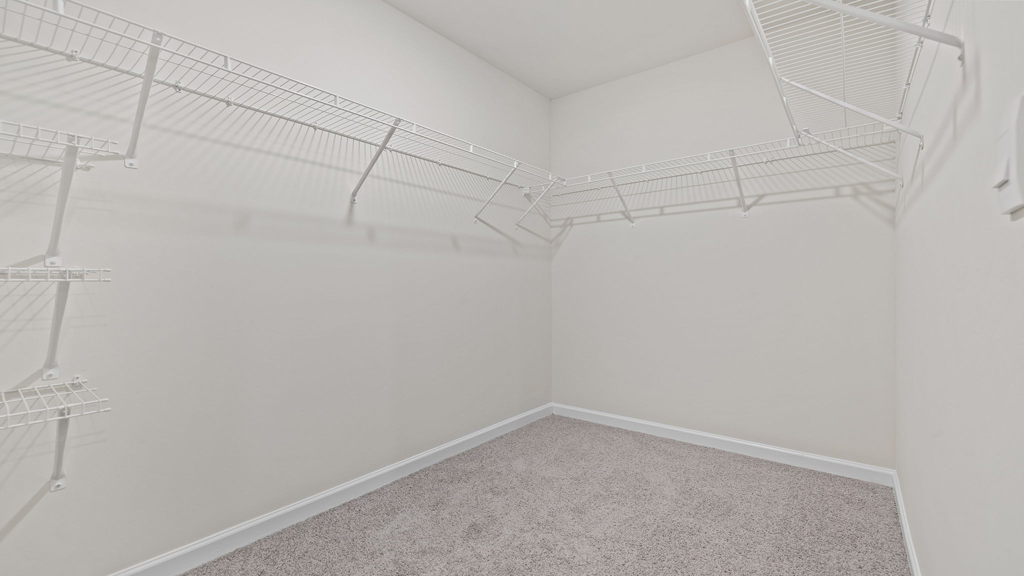 Walk in closet with shelves.