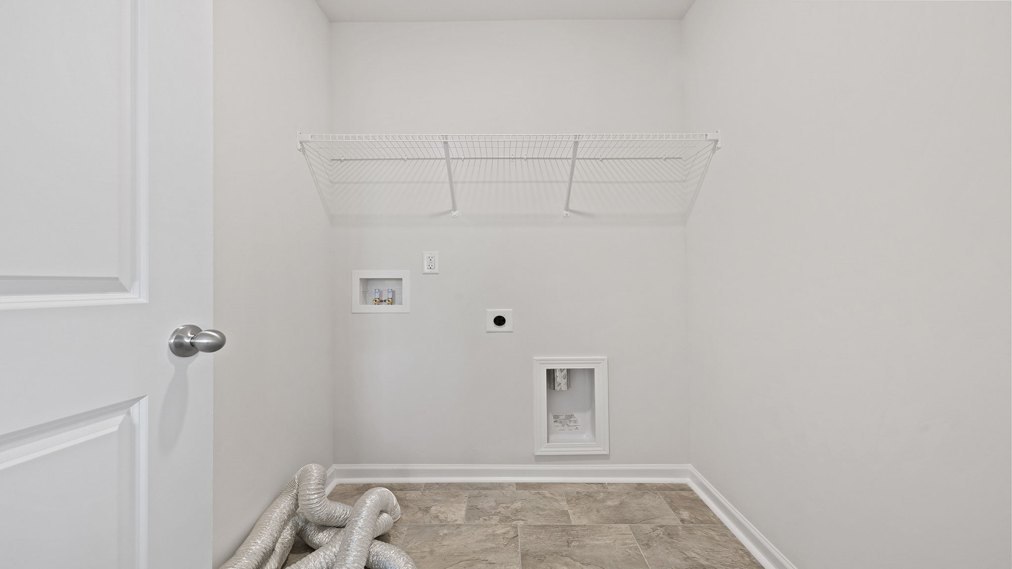 Walk in laundry with shelves.