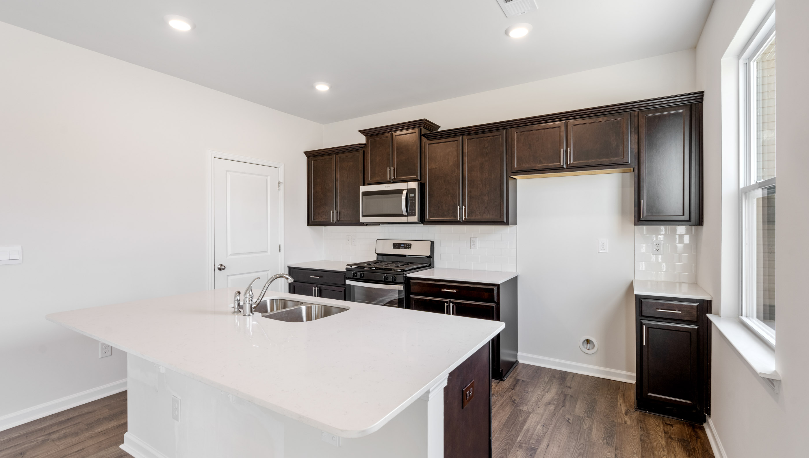Kitchen and island with granite countertops.